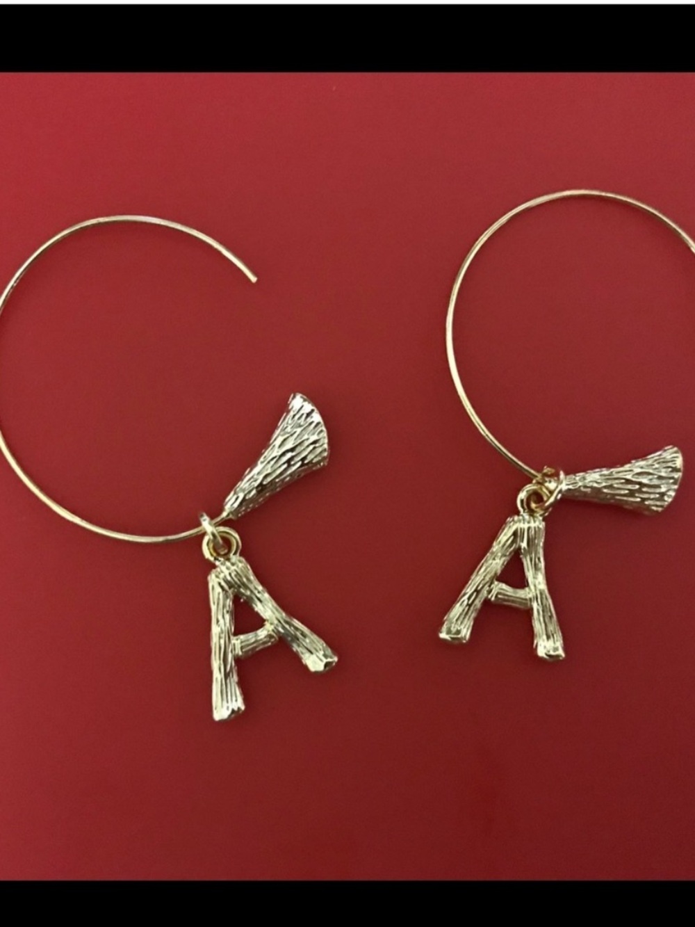 A letter initial earrings in gold color